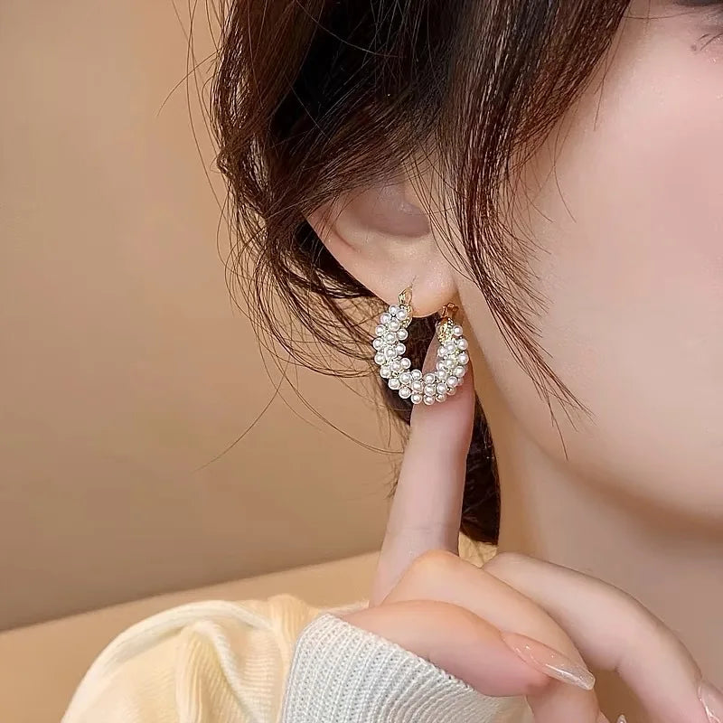 Fashion-forward pearl hoop earrings in large round style, perfect for special occasions.