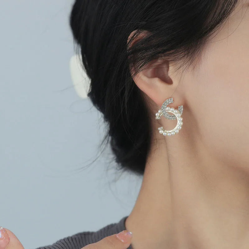 Chic initial shaped earrings with micro inlaid pearls and rhinestone embellishments.