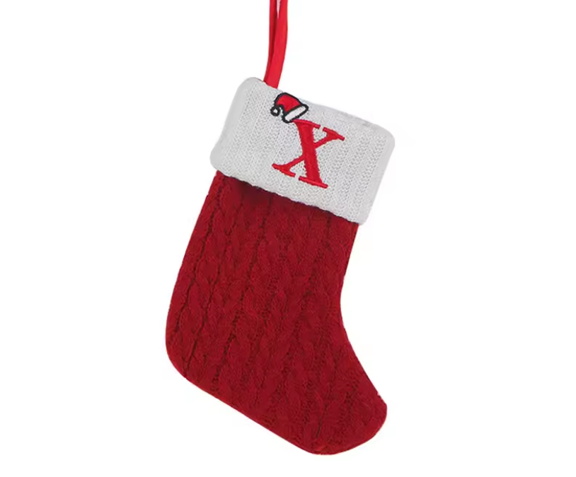 Red knitted Christmas stocking with white cuff and red 'X' on a white background
