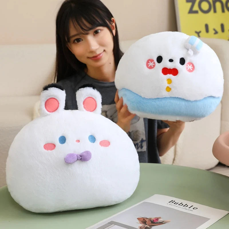 Person holding two plush toys resembling cartoon characters on a table.
