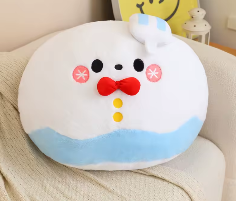 Round plush toy with a face design on a chair