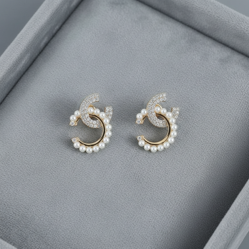 Pair of pearl earrings on a gray jewelry box