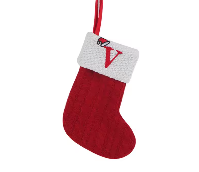 Red Christmas stocking with white cuff and letter 'V' on a white background