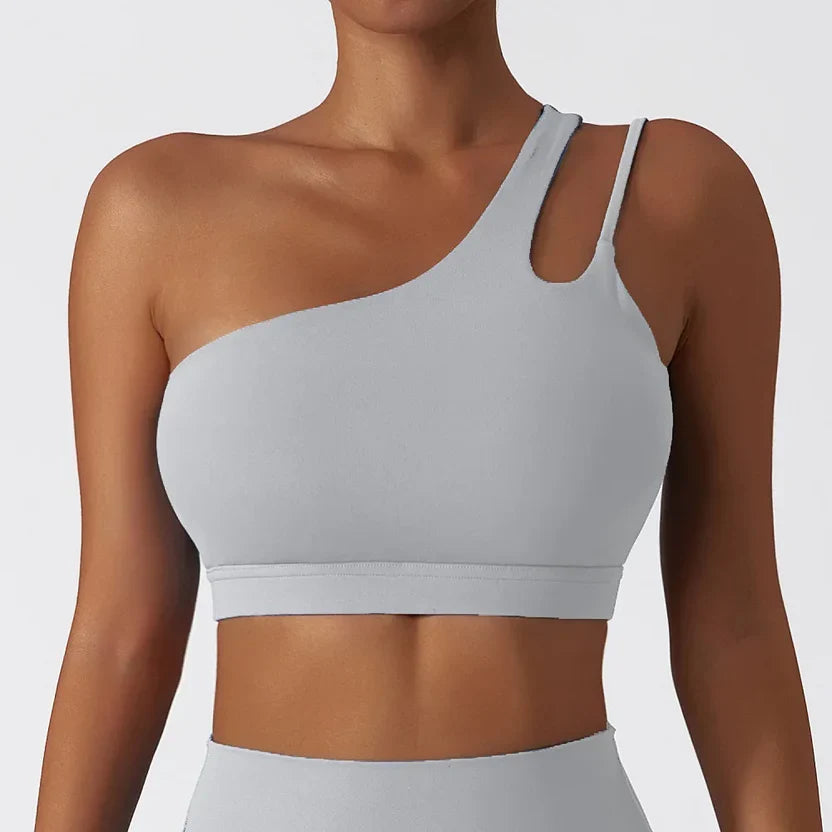 Light gray sports bra worn by a person on a plain background