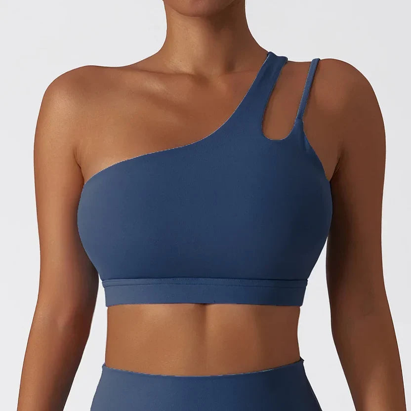Blue sports bra worn by a person on a plain background