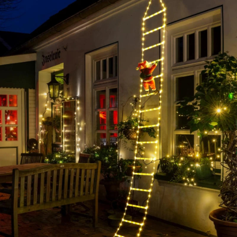Light-up climbing Santa figure on balcony railing