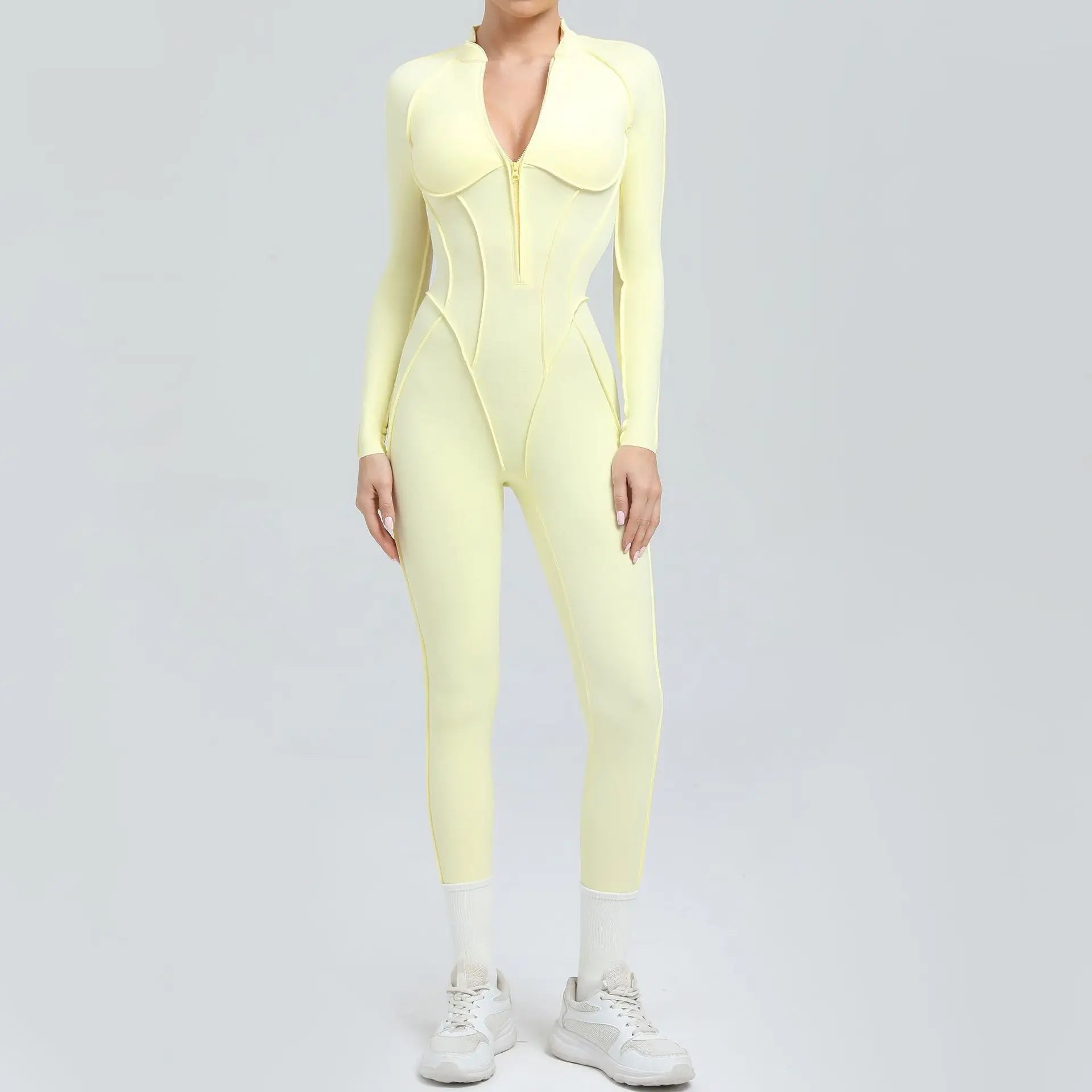 Person wearing a light yellow bodysuit on a gray background