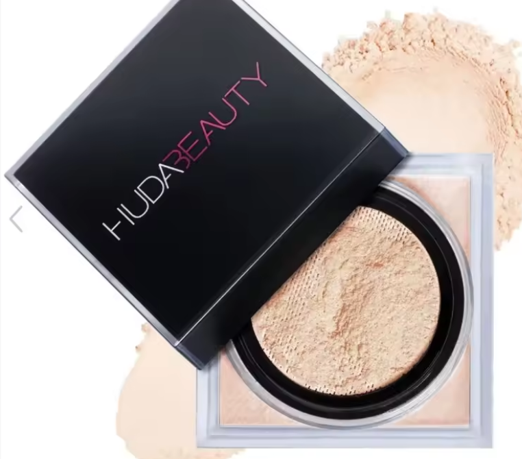 Huda Beauty powder compact with open lid showing light beige powder.
