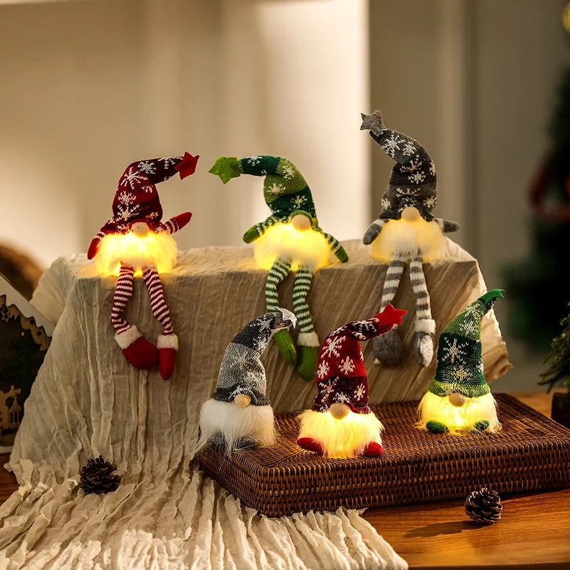 Set of LED gnome figurines on a woven tray with a soft blanket and blurred background