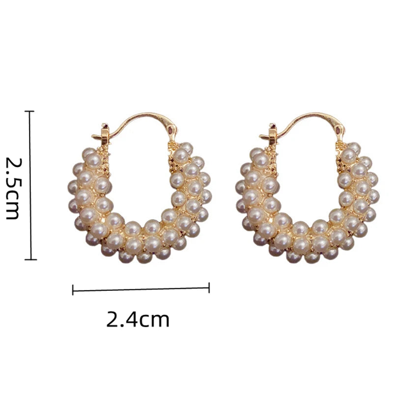 Stylish big hoop earrings adorned with classic pearls, ideal for evening wear.