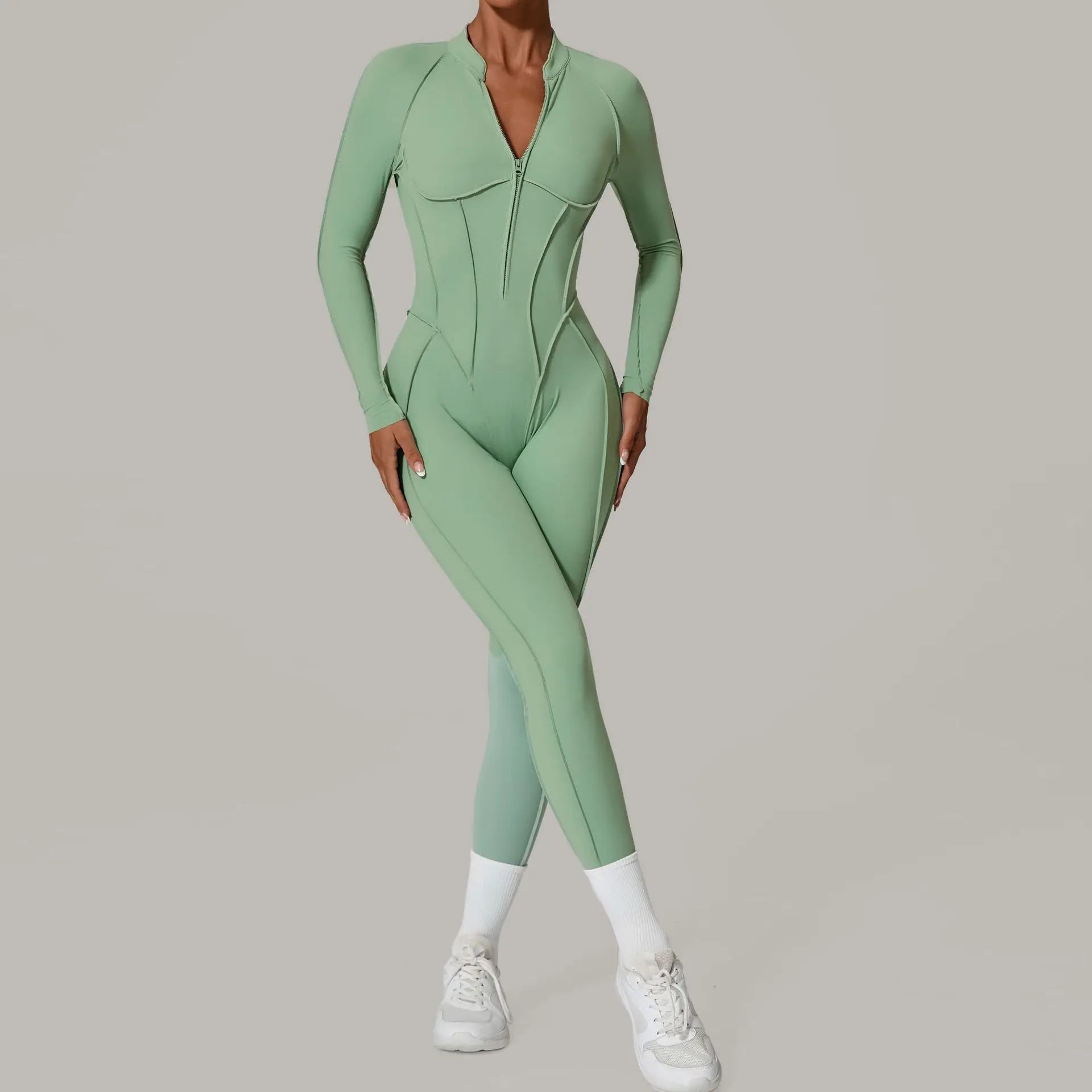 Person wearing a green jumpsuit on a plain background