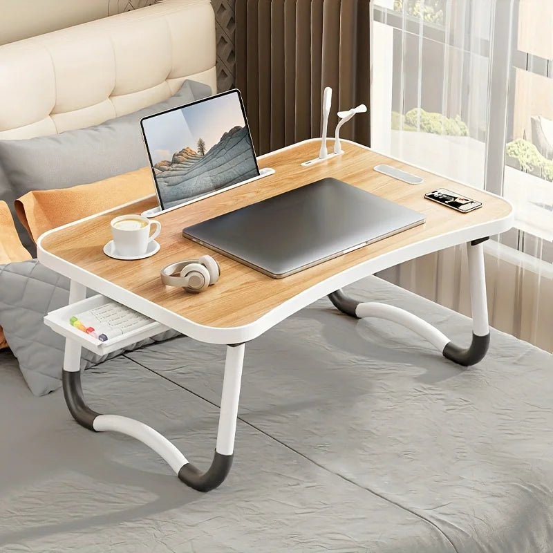 Foldable laptop desk with adjustable legs, USB light, and phone/tablet holder.