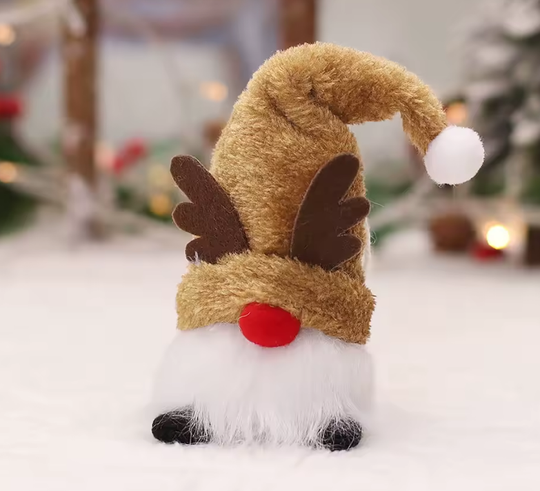 Plush gnome with reindeer hat and antlers on a snowy background