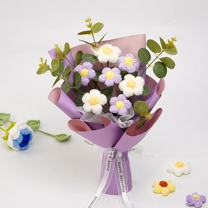 Bouquet of artificial flowers in a purple holder with a 'Happy Birthday' ribbon on a white background