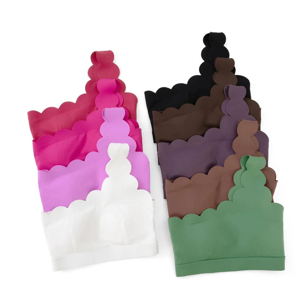 Fitness model in seamless leggings and bra stretching on mat