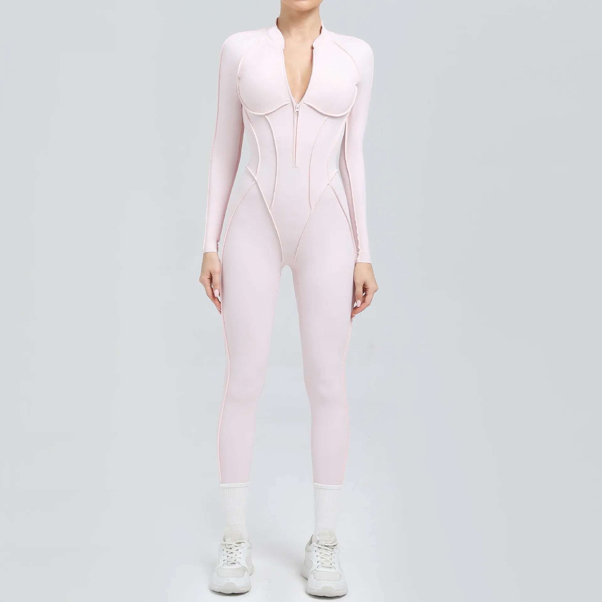 Person wearing a pink bodysuit on a light gray background