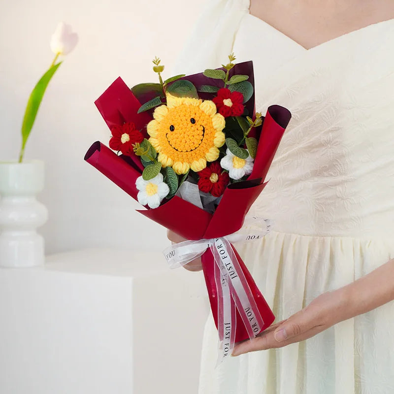 Bouquet with a smiley face flower held by a person in a white dress.
