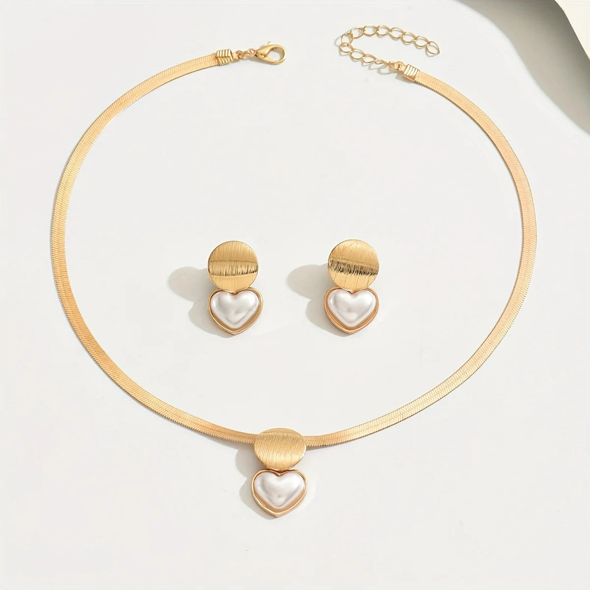Stylish golden jewelry set featuring a delicate necklace and matching earrings.