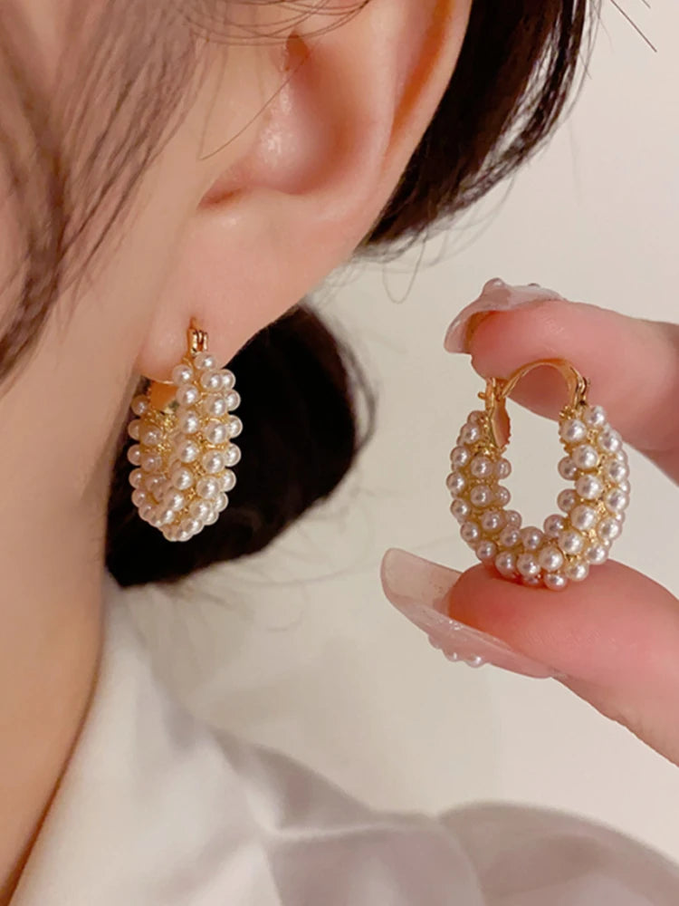 Bold, statement-making pearl hoop earrings with a classic round design for women.