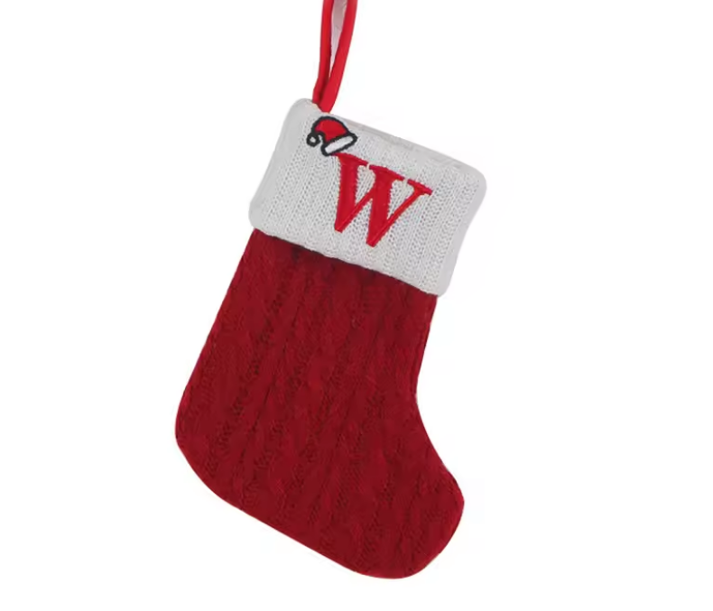 Red Christmas stocking with a white cuff featuring the letter 'W' on a white background