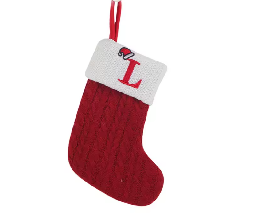 Red Christmas stocking with a white cuff featuring the letter 'L' on a white background
