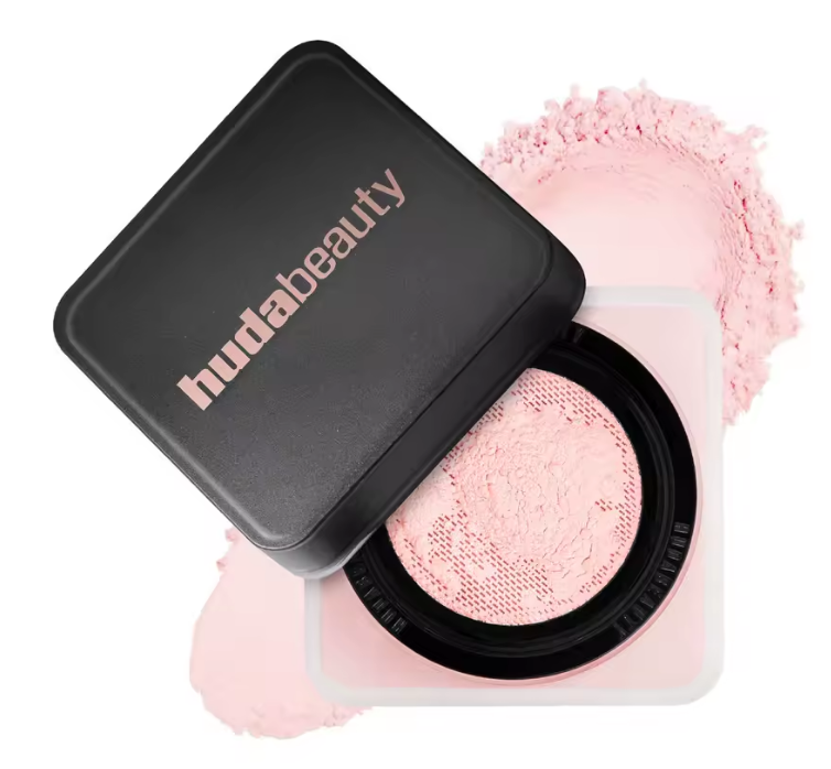 Huda Beauty compact with pink powder on a white background