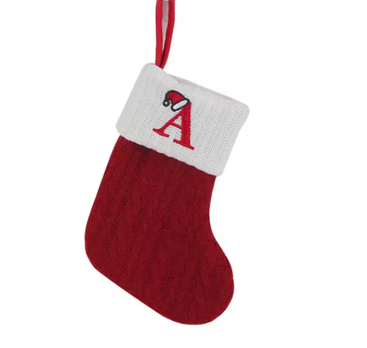 Red knitted Christmas stocking with a white cuff featuring a red letter 'A' on a white background.