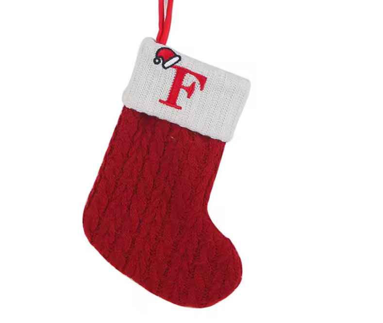 Red knitted Christmas stocking with a white cuff featuring a red letter 'F' on a white background.