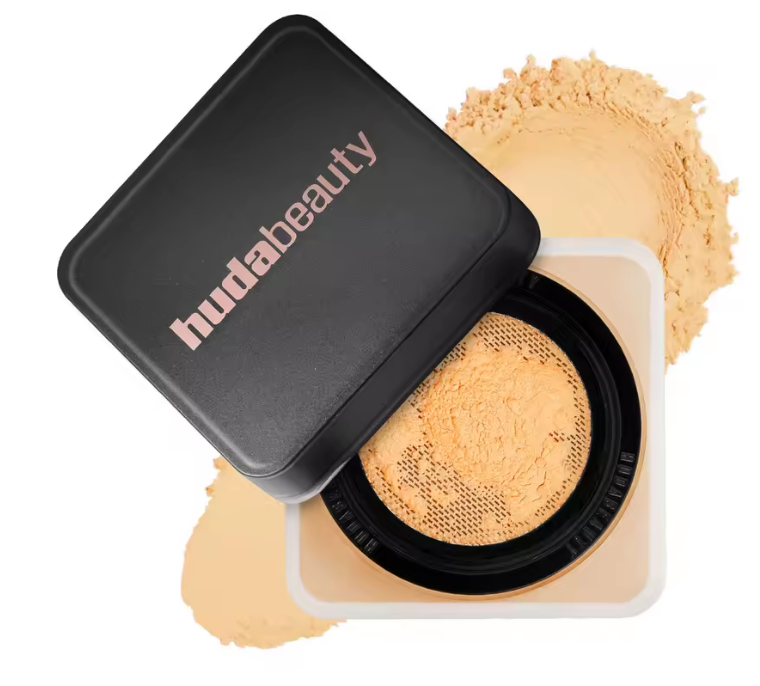 Huda Beauty compact powder with black lid on a white background